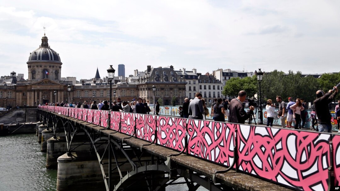 Temporary panels covered of graffiti are seen on the Pont des Arts bridge, in Paris, June 10, 2015.