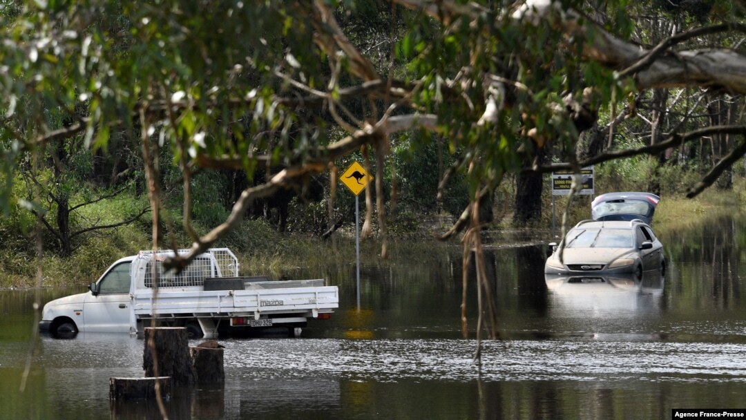 Cars sit in floodwaters in Londonderry, a suburb outside Sydney on March 25, 2021, as flood-stricken residents along Australia's east coast began a massive clean up effort following days of floods. 