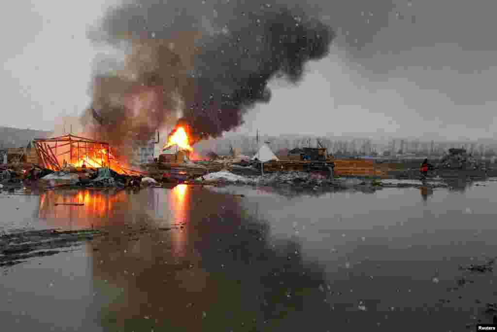 Buildings burn after being set alight by protesters preparing to evacuate the main opposition camp against the Dakota Access oil pipeline near Cannon Ball, North Dakota, USA.