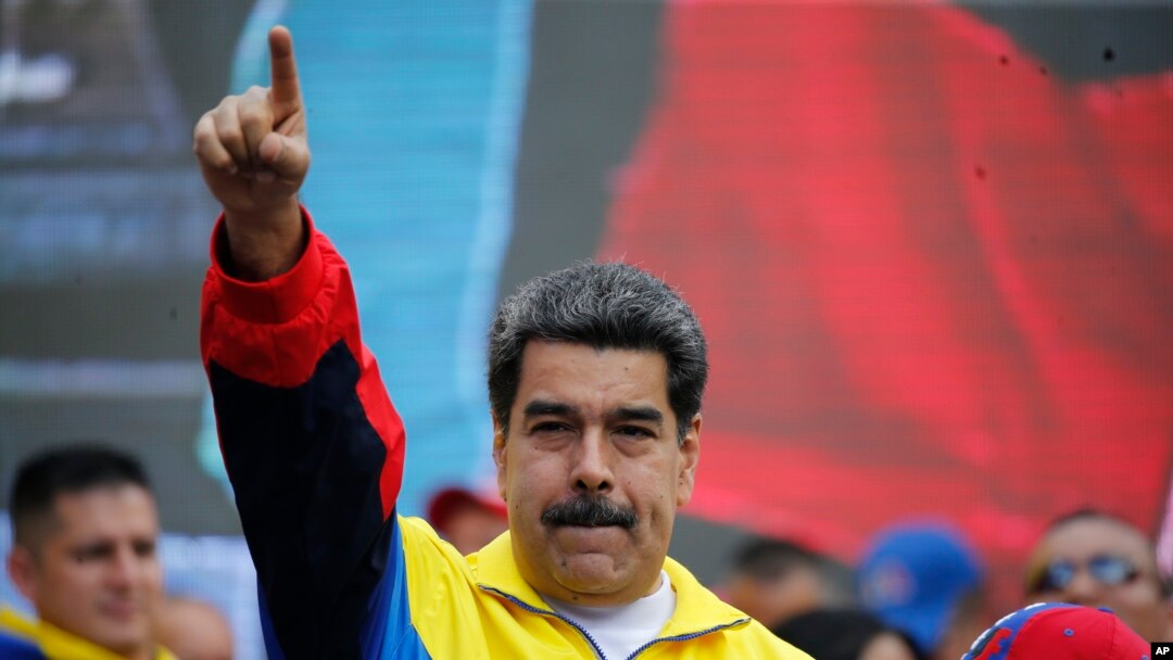 FILE - Venezuela's President Nicolas Maduro leads a rally condemning the economic sanctions imposed by the administration of U.S. President Donald Trump on Venezuela, in Caracas, Venezuela, Aug. 10, 2019.