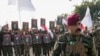 FILE - Members of an Iraqi Shiite militant group attend a funeral for group members killed by a U.S. airstrike, in Baghdad, Feb. 4, 2024. In February, the U.S. struck 85-plus targets in Iraq and Syria linked to Iran's Islamic Revolutionary Guard Corps.