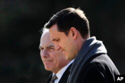 FILE - Then-White House staff secretary Rob Porter, right, walks with White House Chief of Staff John Kelly to board the Marine One on the South Lawn as they leave the White House in Washington, Feb. 2, 2018.
