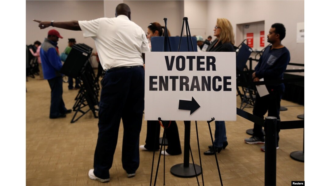 FILE - Voters wait in line to cast their ballots during early voting at the Franklin County Board of Elections in Columbus, in Columbus, Ohio.