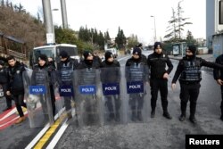 FILE - Turkish police stand guard on a road leading to the Reina nightclub by the Bosphorus, which was attacked by a gunman, in Istanbul, Jan. 1, 2017.
