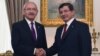 Turkish Caretaker Prime Minister and leader of the Justice and Development Party (AKP) Ahmet Davutoglu (R) shakes hands with the leader of the main opposition Republican People's Party (CHP) Kemal Kilicdaroglu, in Ankara, Turkey, Aug. 10, 2015.