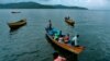 FILE - Fishermen and women return to their homes in Port Blair, in India's Andaman and Nicobar Islands archipelago, Sept. 6, 2007. Authorities say 10 cases have been detected among the Great Andamanese tribe, whose numbers have dwindled to 56.