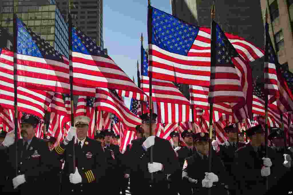 Firefighters march up Fifth Avenue during the St. Patrick's Day Parade in New York City. St. Patrick’s Cathedral displayed both the American and Irish flags and a special Mass was held there before the parade stepped off.