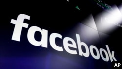 FILE - The logo for Facebook is seen on screens at the Nasdaq MarketSite, in New York's Times Square, March 29, 2018.