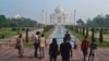 A small number of tourists visit as the Taj Mahal monument is reopened after being closed for more than six months due to the coronavirus pandemic in Agra, India, Sept.21, 2020.