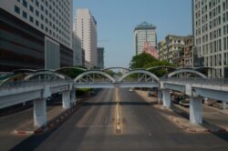 FILE - A car is seen on an empty street in downtown Yangon, Myanmar, March 24, 2021, during what anti-coup protesters called a 'silent strike.'