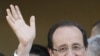 Socialist Party candidate for the presidential election Francois Hollande meets a resident with his companion Valerie Trierweiler, center, as he tours Tulle, after voting , May 6, 2012. 