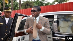 Teodorin Nguema Obiang (R), the son of Equatorial Guinea's president Teodoro Obiang and the country's vice-president in charge of security and defense, arrives at Malabo's Cathdral to celebrate his 41st birthday, June 25, 2013. 