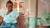 FILE - Antho watches over her son Kaba, two, who is being treated for cerebral malaria at the Tshilundu Referral Hospital in Kasai Oriental Province, DRC. Kaba is now in a coma. Antho is nine months pregnant. This is her eighth pregnancy; she had two miscarriages.