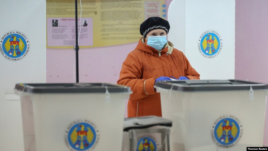 A woman votes at a presidential election in Chisinau, Moldova, Nov. 1, 2020. 
