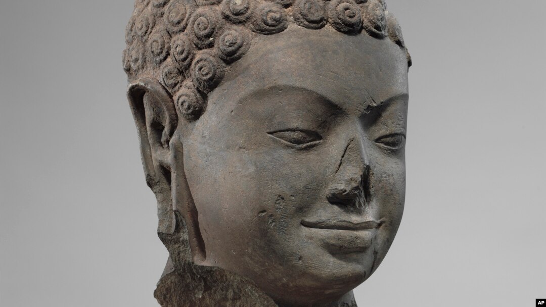 FILE - This December 2005 photo shows a 7th century sculpture titled "Head of Buddha" at the Metropolitan Museum of Art in New York. The sculpture is one of 16 pieces of artwork that the museum said it will return to Cambodia and Thailand.