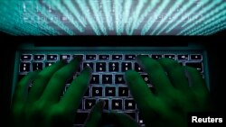 FILE - A man types on a computer keyboard in a Feb. 28, 2013, illustration picture.