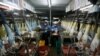 FILE - Workers collect rubber gloves at Top Glove's factory in Klang, outside Kuala Lumpur.