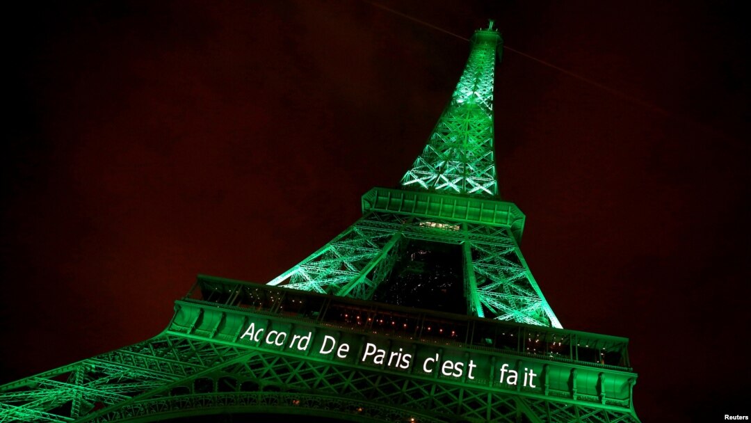 FILE - The Eiffel tower is illuminated in green with the words "Paris Agreement is Done," to celebrate the Paris U.N. Climate Change agreement in Paris, France, Nov. 4, 2016.
