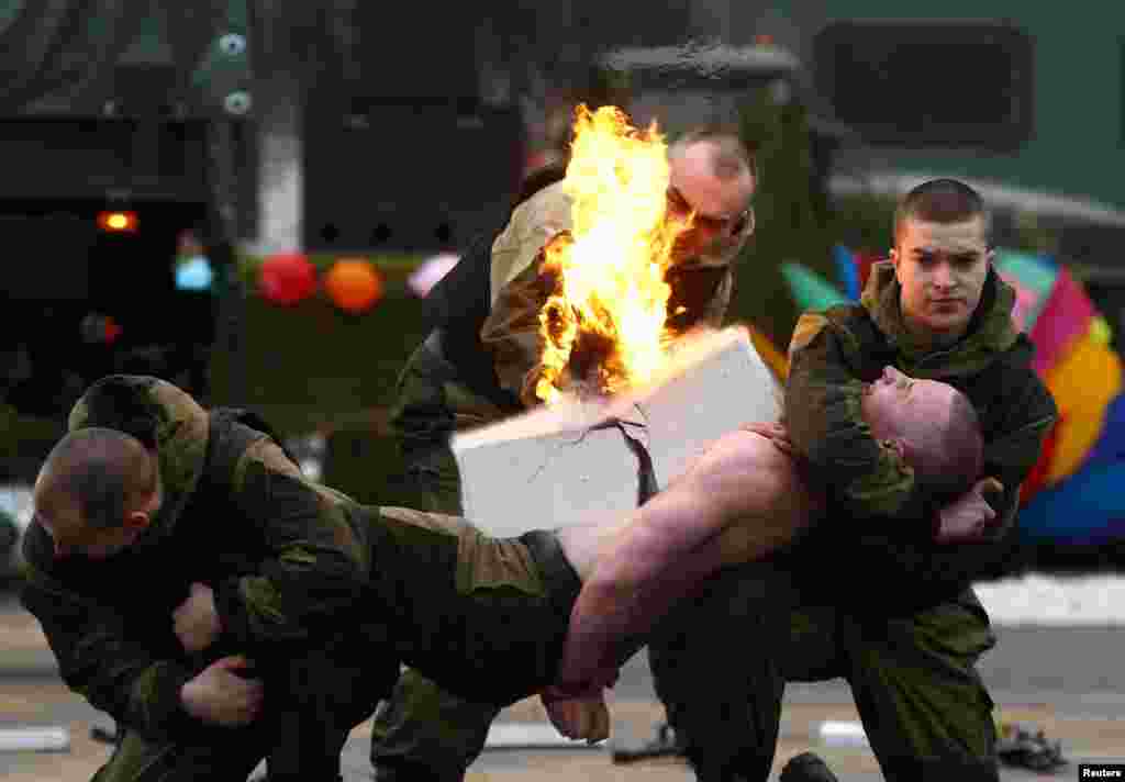 Servicemen of the Belarussian Interior Ministry's special forces unit perform during Maslenitsa celebrations, a pagan holiday marking the end of winter celebrated with pancake eating and shows of strength, at their base in Minsk, Belarus.