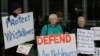 FILE - Supporters demonstrate outside the Australian Capital Territory Supreme Court in Canberra, Australia, June 27, 2019, where a former army lawyer was charged with leaking secret documents to ABC reporters alleging misconduct in Afghanistan.