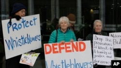 FILE - Supporters demonstrate outside the Australian Capital Territory Supreme Court in Canberra, Australia, June 27, 2019, where a former army lawyer was charged with leaking secret documents to ABC reporters alleging misconduct in Afghanistan.