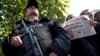 A man holds the latest copy of Cumhuriyet outside its headquarters after Turkish police detained the chief editor and several of the opposition paper's senior staff, in Istanbul, Oct. 31, 2016, amid growing fears over Turkey's widening crackdown on independent media. 