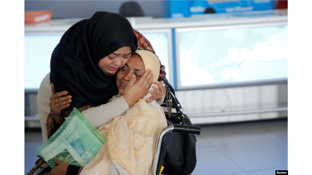 A woman greets her mother after she arrived from Dubai on Emirates Flight 203 at John F. Kennedy International Airport in Queens, New York, Jan. 28, 2017.