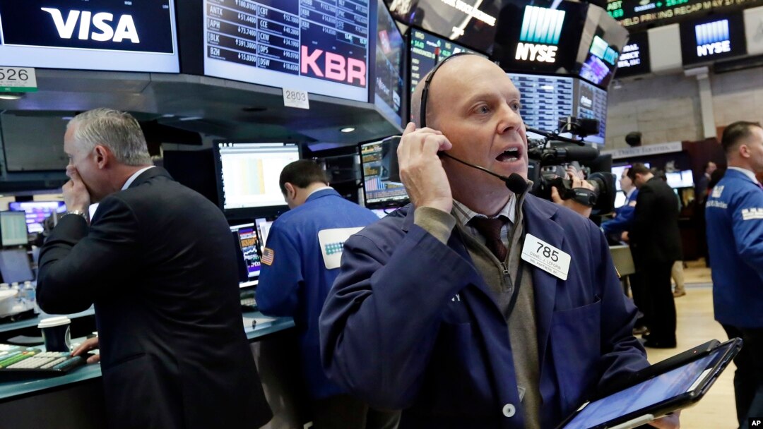 Trader Daniel Leporin, right, works on the floor of the New York Stock Exchange, May 17, 2017. 
