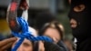 FILE - A member of Iran's special police forces checks the rope before an execution by hanging, in Tehran, Aug. 2, 2007. 