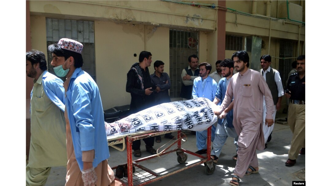 FILE - Hospital workers push a stretcher carrying the body of a policeman who was one of the policemen shot dead in Quetta, Pakistan, July 13, 2017.