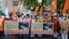 Supporters of Vishwa Hindu Parishad, or World Hindu Council, hold posters showing coffins of Indian army soldiers killed in clashes with China, during a protest in Ahmedabad, India, June 20, 2020. 
