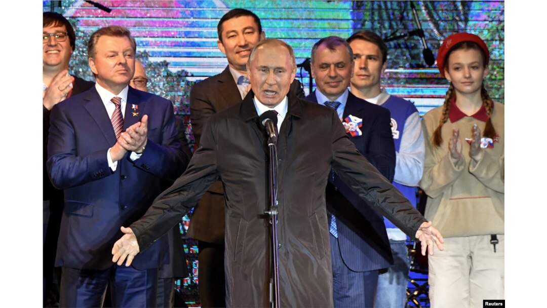 Russian President Vladimir Putin addresses the crowd during a concert marking the fifth anniversary of Russia's annexation of Crimea, in Simferopol, March 18, 2019.