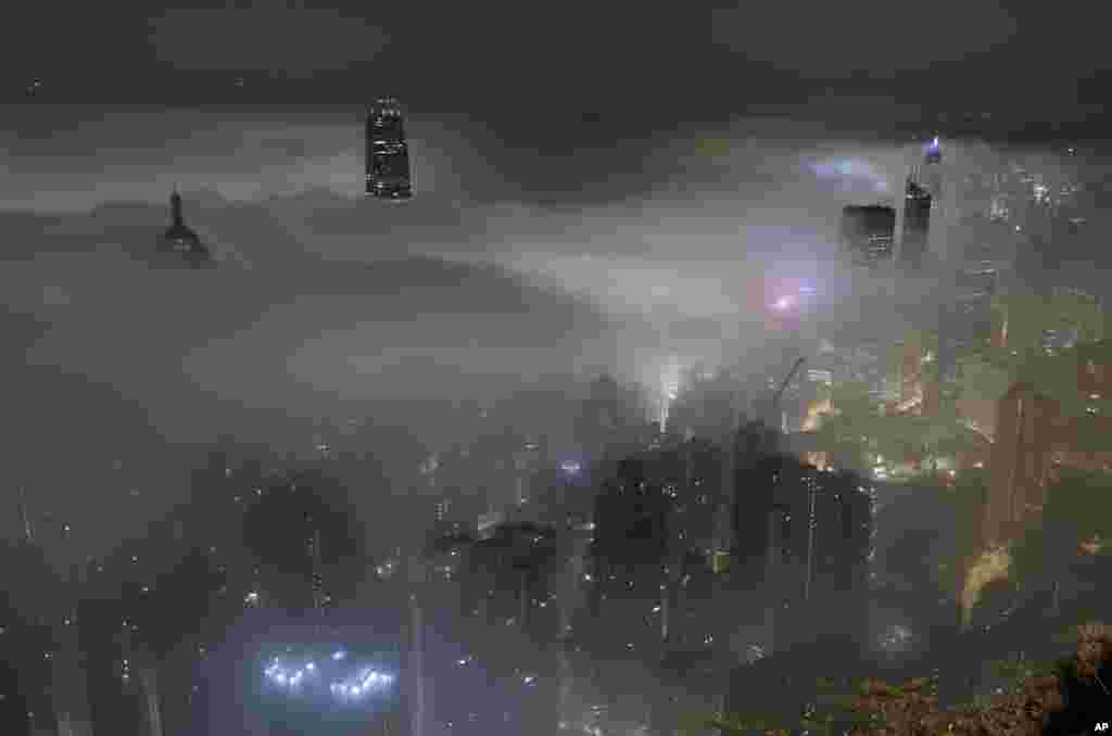 High-rise buildings are partly covered by heavy fog at Hong Kong's Victoria Harbour, March 20, 2017.