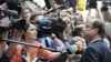 France's President Francois Hollande (R) talks to the media as he arrives at an informal EU leaders summit in Brussels, May 23, 2012.