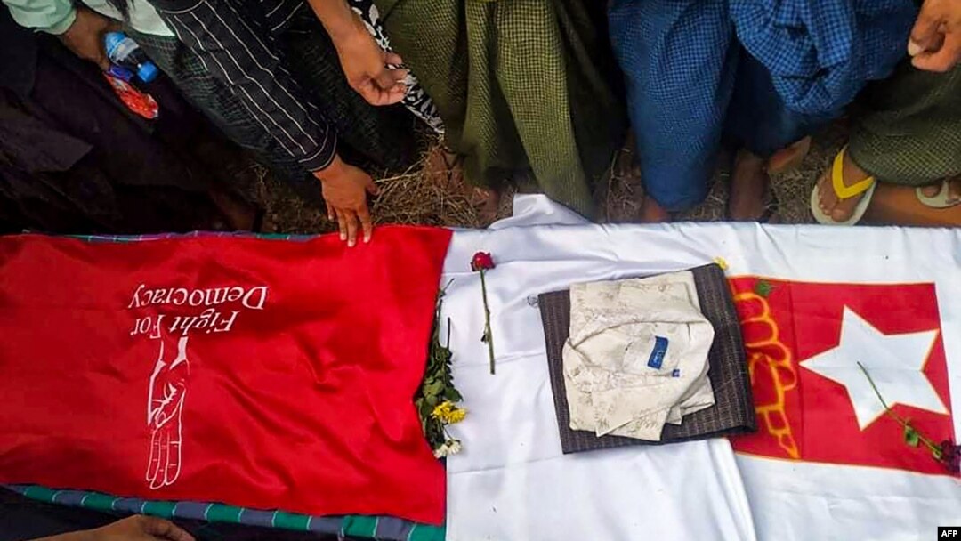 This photo taken May 10, 2021, and received courtesy of an anonymous source via Facebook on May 19, 2021, shows mourners standing around the coffin of poet Khet Thi during his funeral in Pearl town, Myanmar.