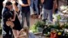 Italian Premier Matteo Renzi, left, comforts a woman at the end of the state funeral service for some of the victims of the earthquake that hit central Italy last Wednesday, in Ascoli Piceno, Italy, Aug. 27, 2016