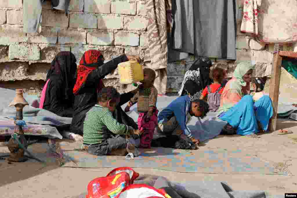 Internally displaced people sit at a makeshift camp for IDPs in al-Jarahi, south of the Red Sea port city of Houdieda, Yemen.