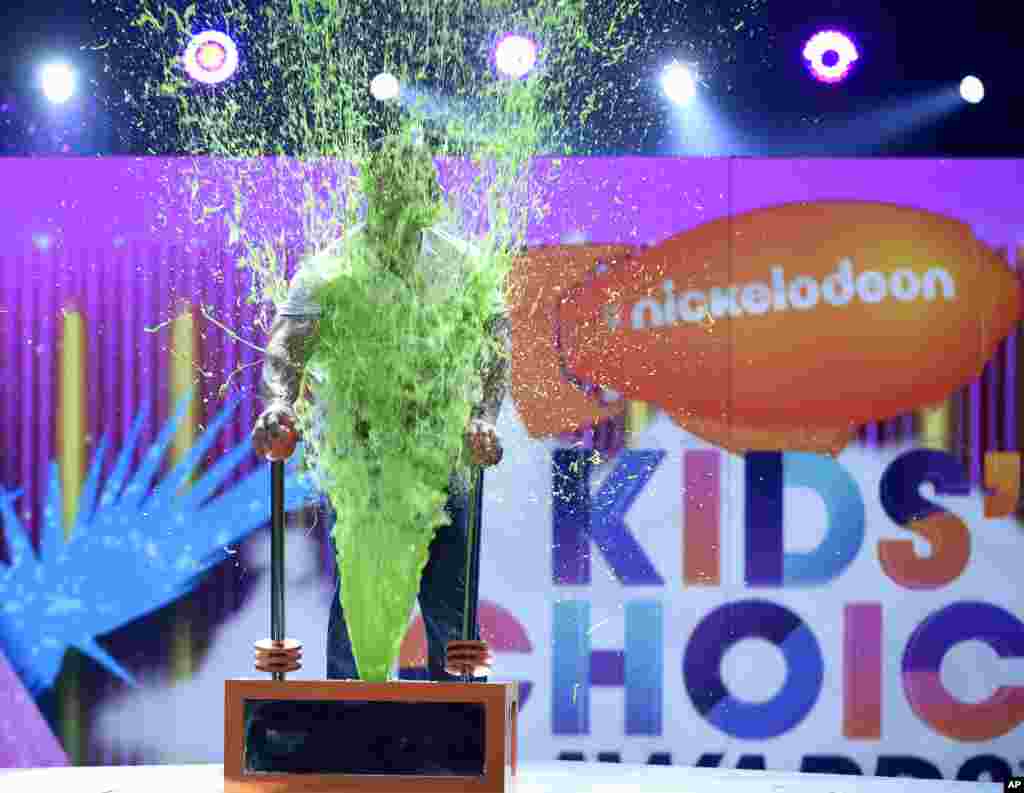 Host John Cena gets slimed at the Kids' Choice Awards at the Galen Center in Los Angeles, California, March 11, 2017.