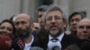 Can Dundar, the editor-in-chief of opposition newspaper Cumhuriyet, right, and Erdem Gul, left, the paper's Ankara representative, speak to the media after their trial in Istanbul, March 25, 2016.