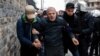 Plainclothes police detain a man in Istanbul, one of more than 200 people who were protesting peacefully against curfews and operations in mainly Kurdish cities and towns in southeastern Turkey, Jan. 3, 2016. 