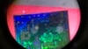 A Chinese microchip is seen through a microscope set up at the booth for the state-controlled Tsinghua Unigroup project which is driving China's semiconductor ambitions during the 21st China Beijing International High-tech Expo in Beijing, China, May 17, 