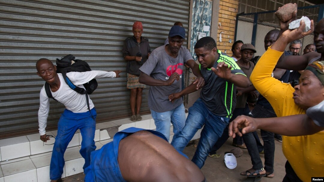 A vigilante mob attacks a Nigerian migrant outside a church in Pretoria, South Africa, Feb. 18, 2017. 