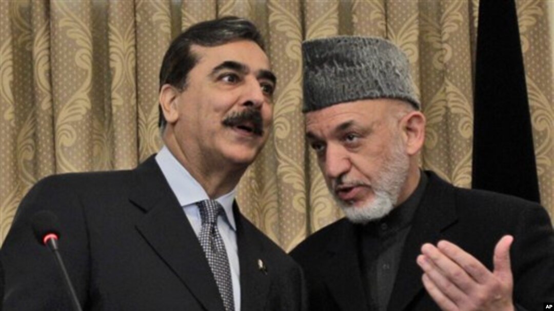 Pakistan's Prime Minister Yousuf Raza Gilani, left, speaks with Afghanistan's President Hamid Karzai during a news conference in Kabul, Afghanistan, April 16, 2011