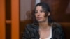 FILE - Ksenia Karelina, also known as Khavana, sits in a glass cage in a court room in Yekaterinburg, Russia, June 20, 2024. 