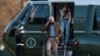 President Joe Biden, followed by his granddaughter Natalie Biden, disembark Marine One on the South Lawn upon arrival at the White House in Washington from a weekend trip to Wilmington, Del., March 14, 2021. 