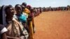 FILE - Internally displaced people, who recently arrived in Wau, South Sudan, due to armed clashes in surrounding villages, wait to be registered by the International Organization for Migration and the World Food Program, May 11, 2016.