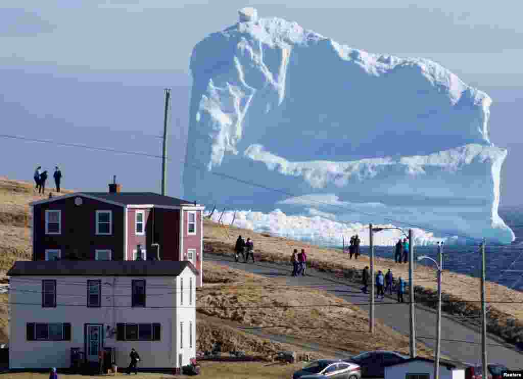 Residents view the first iceberg of the season as it passes the South Shore, also known as "Iceberg Alley", near Ferryland Newfoundland, Canada.