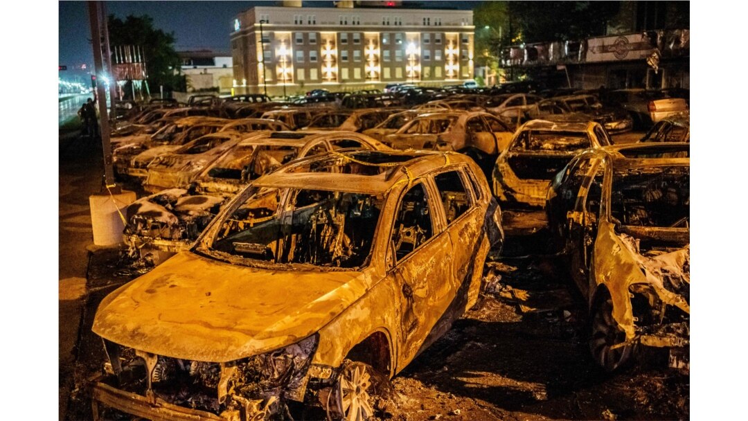 The remains of the cars burned by protesters the previous night during a demonstration against the shooting of Jacob Blake are seen on a used cars lot in Kenosha, Wis., on Aug. 26, 2020.
