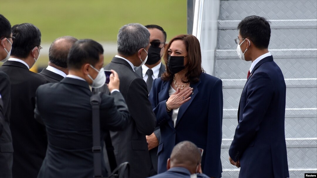 U.S. Vice President Kamala Harris is greeted by Singapore Foreign Minister Vivian Balakrishnan and his delegation, as she arrived at Paya Lebar Air Base in Singapore, Aug. 22, 2021. 