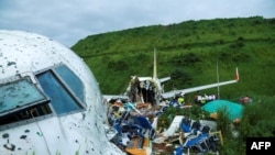 Officials inspect the wreckage of an Air India Express jet at Calicut International Airport in Karipur, Kerala, on Aug. 8, 2020.
